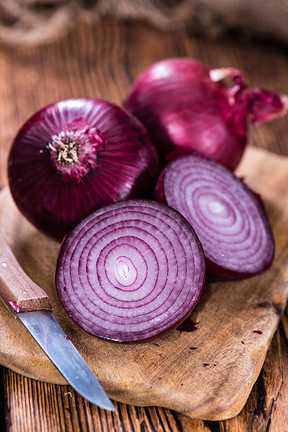 Some Red Onions(detailed close-up shot) on wooden background
